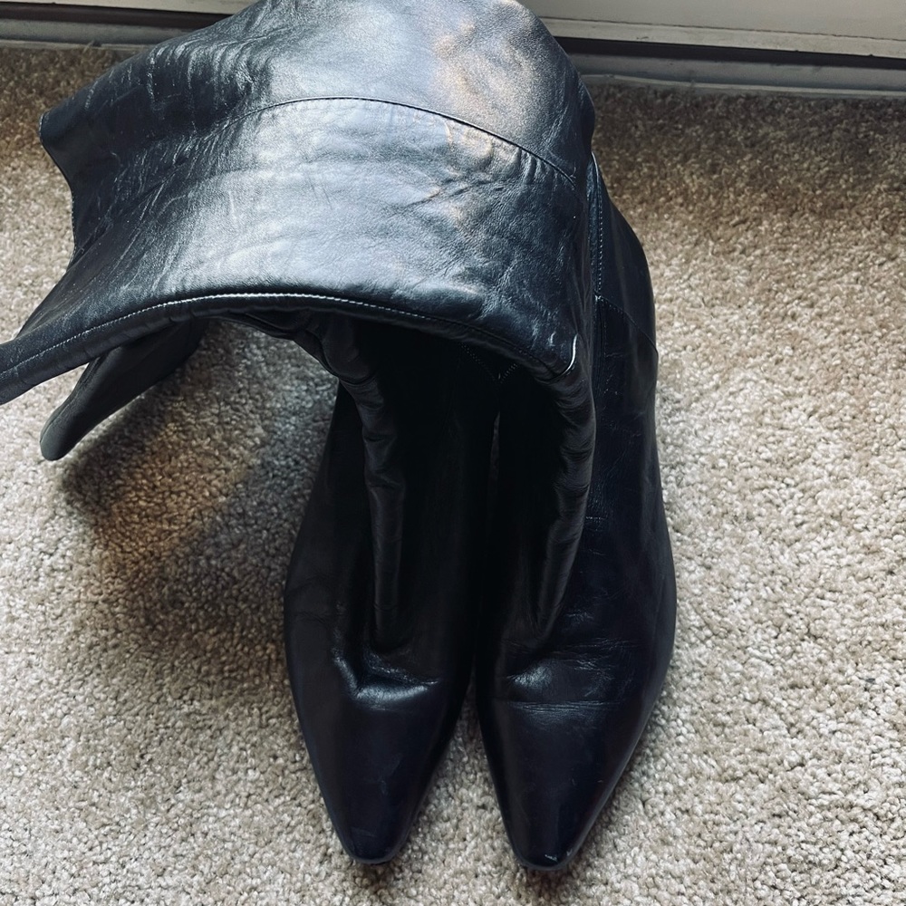 Black leather boot right under the knee